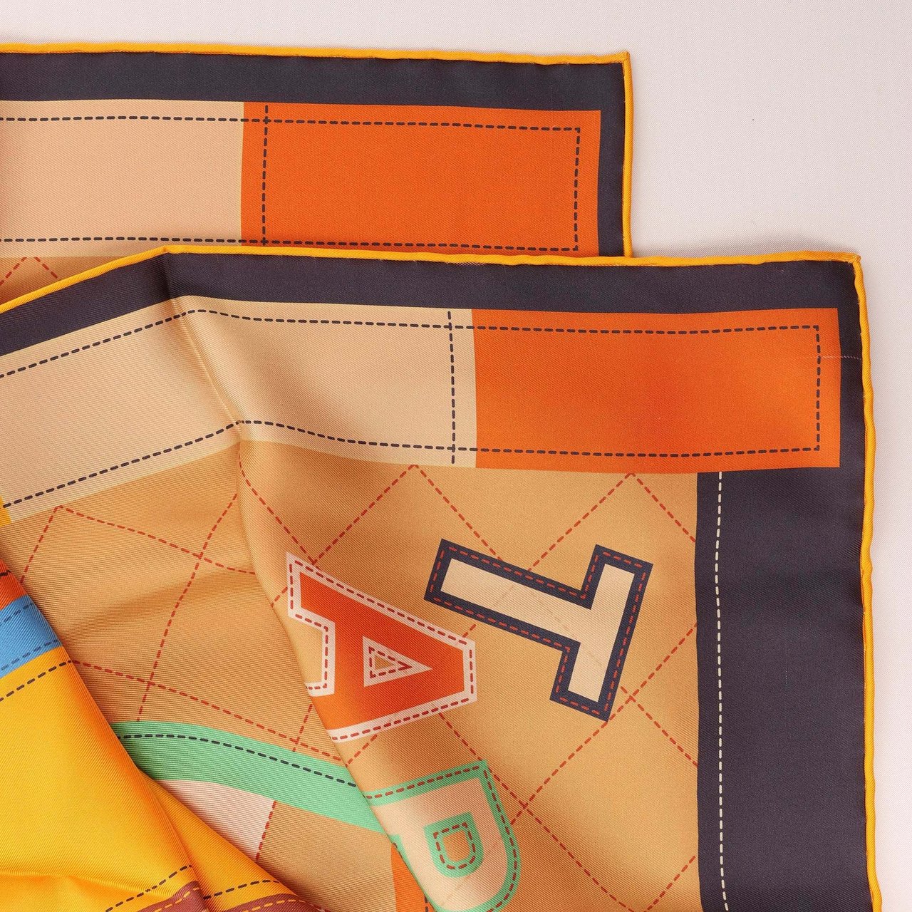 Hermès Carré 90 Double Face "Tapis de Selle" Silk handkerchief in Orange Oranje