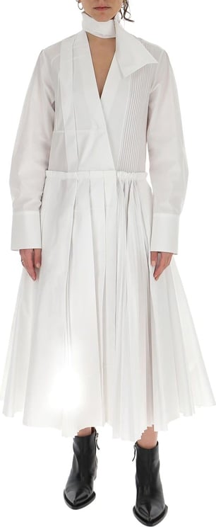 Jil Sander White cotton mock-neck pleated dress from JIL SANDER featuring pleat detailing, mock neck, V-neck, long sleeves, buttoned cuffs and pleated skirt. Wit